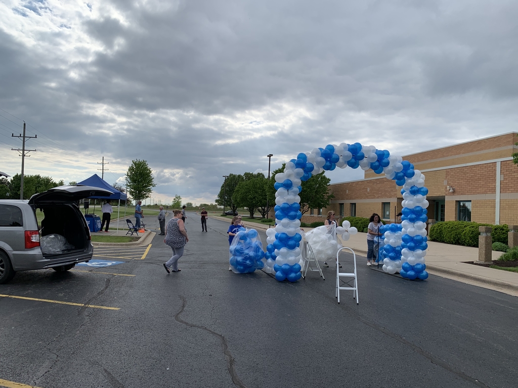 PTO putting up a balloon arch for 8th Grade Graduation.